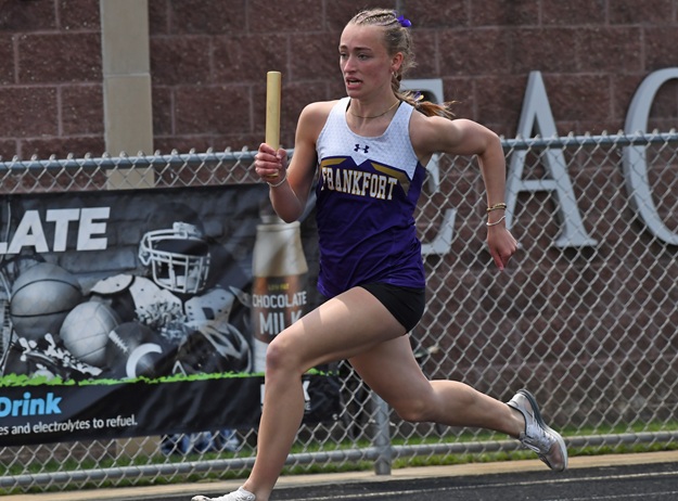 Alice Luther rounds a curve during a winning relay.