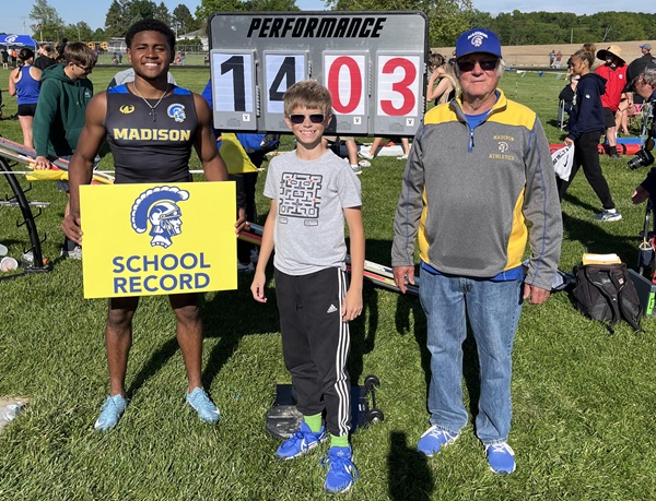 At left, JaLonn Borders stands for a photo with Larry Van Valkenburg and Larry’s grandson Noah after breaking the school’s pole vault record during last season’s Lenawee County Championships.