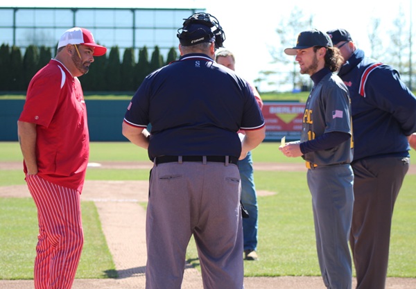 Welch, far left, stands at the plate for a pregame conference before taking on Capac.