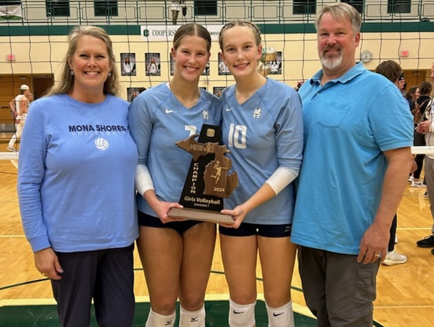Jennifer, Maddie, Laynie and Mike Russell pose for a photo with the Sailors' Division 1 District championship trophy Nov. 7, 2024, at Coopersville. 