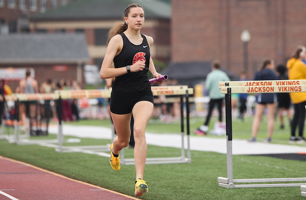 Berkley Holtz carries the baton during her leg in the 3,200-meter relay. 