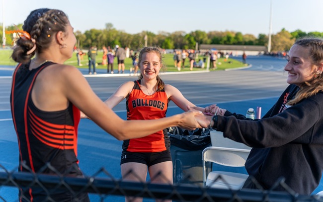 Summerfield 1,600 relay racers (left to right) Abby Raymond, Alice Van Camp and Ost get together to “Triple A Power Up.”