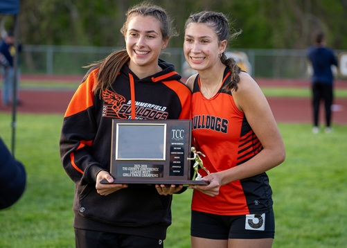 Grace Raymond (left) and Abby Raymond hold up Summerfield's first league title trophy since 1990.