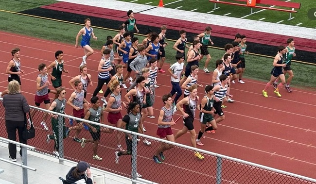 Runners move toward the starting line before their relay. 
