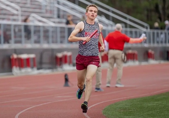 Milford’s Kyle O’Rourke rounds a curve during a relay. 