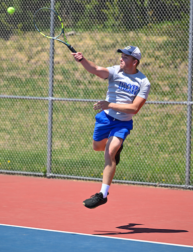 Kingsford’s Landon Adam takes to the air to return a volley at No. 1. 