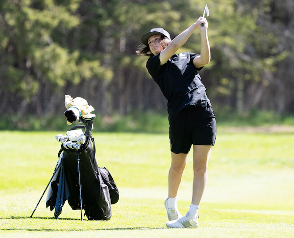 Cedarville/DeTour's McKenna Smith follows an approach shot. 
