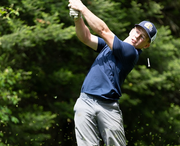 Lake Linden-Hubbell’s Brady Axford follows a tee shot. 