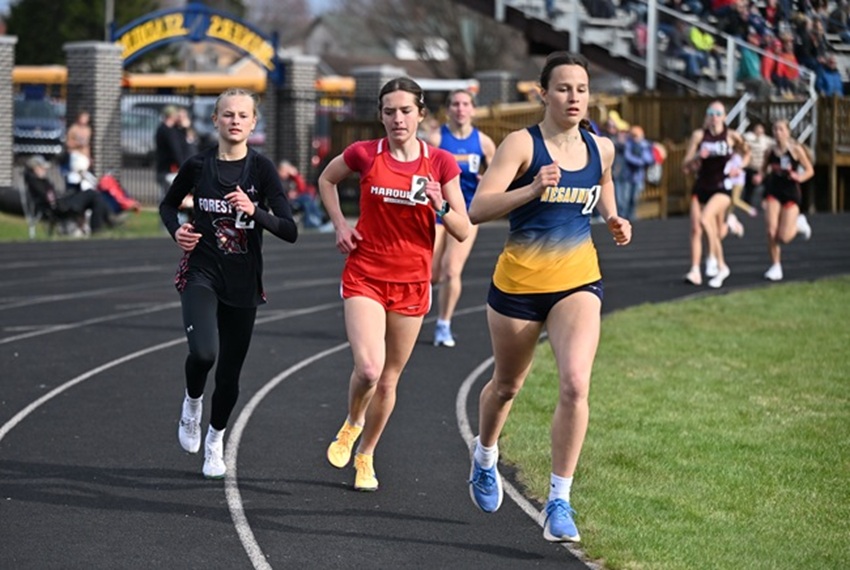 From left, Crystal Falls Forest Park's Audrey Williams, Marquette's Emma Ziegler and Negaunee's Keira Waterman run the 800 at the Negaunee Lions Invitational on May 8. Waterman took first place, Williams second and Marquette's Ziegler took third.