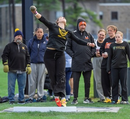 Zielinski launches the shot while a gathered crowd watches.