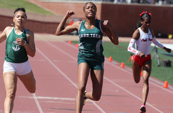 Detroit Cass Tech's Malise Brown, middle, crosses the finish line in record time in the 100.