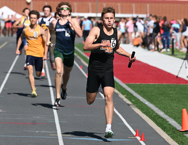 Elk Rapids' Garett Godden sets the pace for the winning 1,600 relay. 
