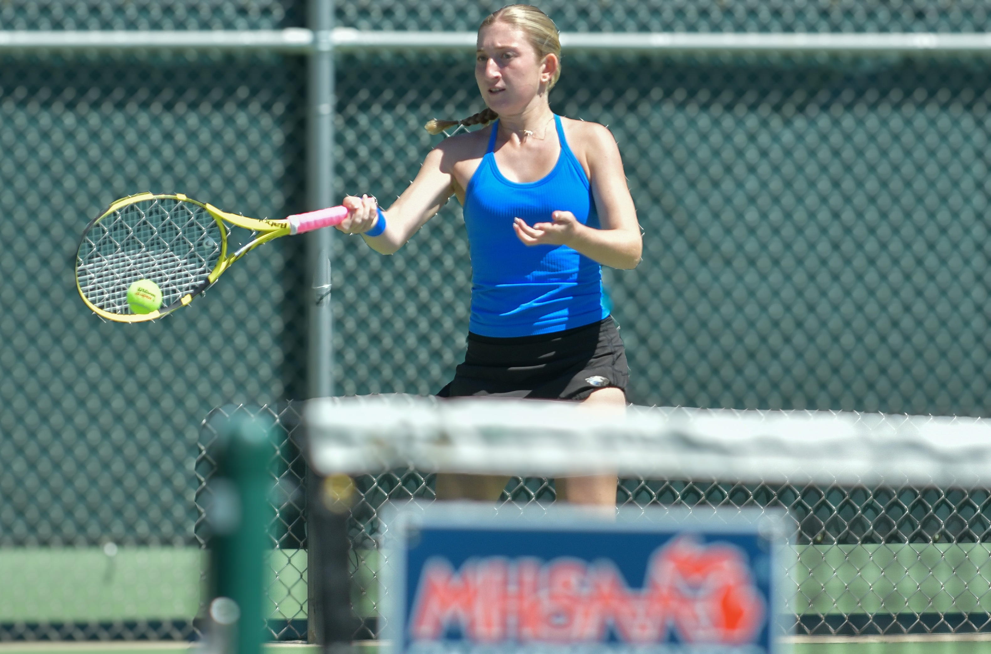 A Utica Eisenhower tennis player hits a forehand. 