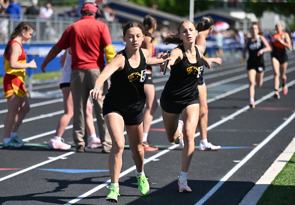 Ewen Trout Creek's Leona Schutz hands off the baton to Alyssa DeCremer during the 3,200 relay. E-TC won the race with team members also including Emma Besonen and Bree Besonen. 