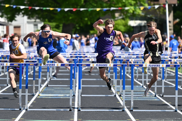 Brimley's Brady Leblanc, second from left, and L'Anse's Connor Kemppainen, just to his right, jump over the last hurdle in the 100 hurdles. 