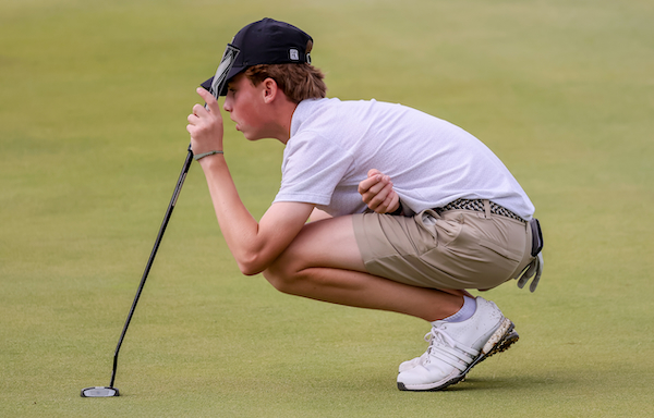 Adams’ Ben Vento lines up a putt.