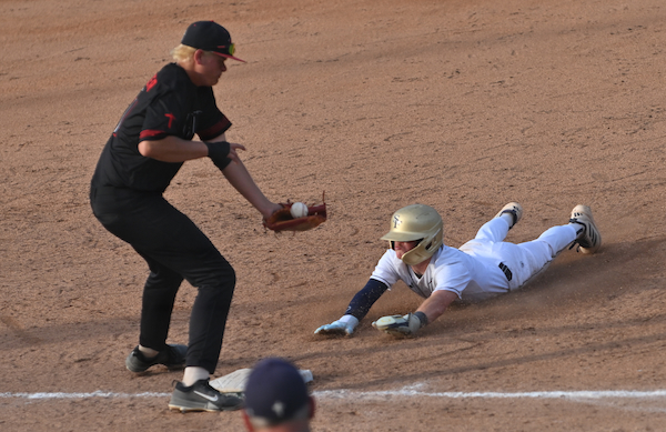 A Traverse City St. Francis runner attempts to get back to first base during his team's win over Rochester Hills Lutheran Northwest.&nbsp;