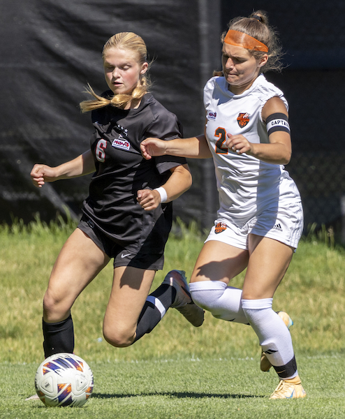 Troy’s Kaylee Worrell (6) controls the ball while Rockford’s Rylan Potter attempts to take possession.