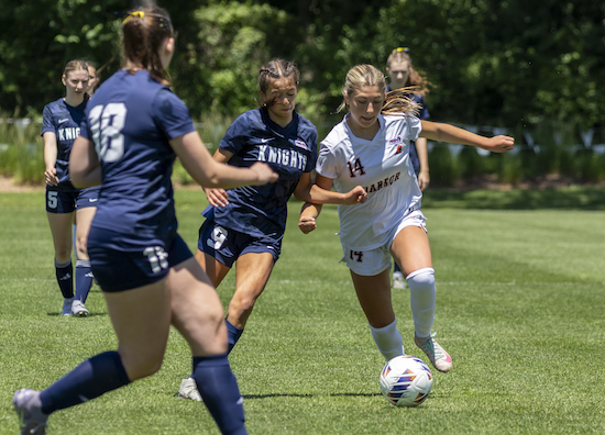 Donley (9) battles the Rams’ Addison Zulski (14) for possession. &nbsp;