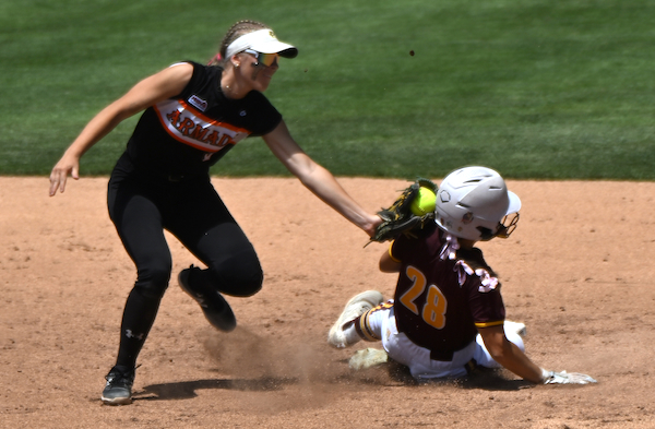 Tigers shortstop Helena Fettue applies a tag on Mercy’s Sophia Chaput (28) as she slides into second base.