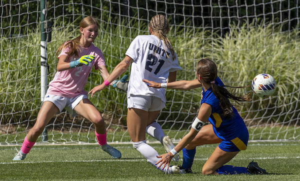 Mateer controls possession while Grand Rapids West Catholic’s Elise Savickas (6) pursues.