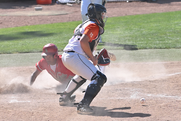 The Irish's Maxim Boykin Lynch crosses the plate as the ball lands in front of Marcellus catcher Eli Torres.