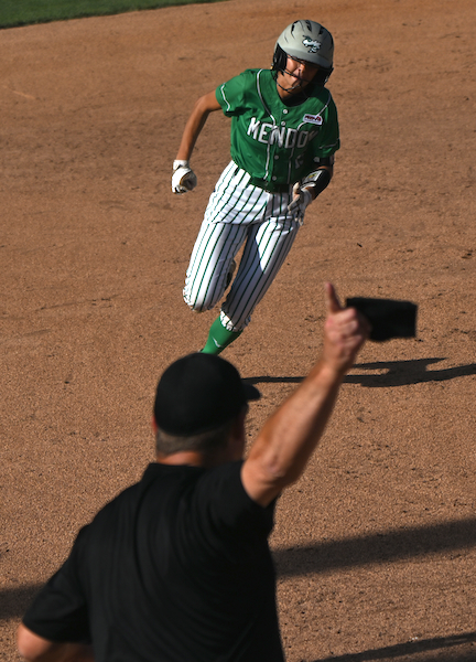 Jadyn Samson (15) rounds third base as her coach signals her home.