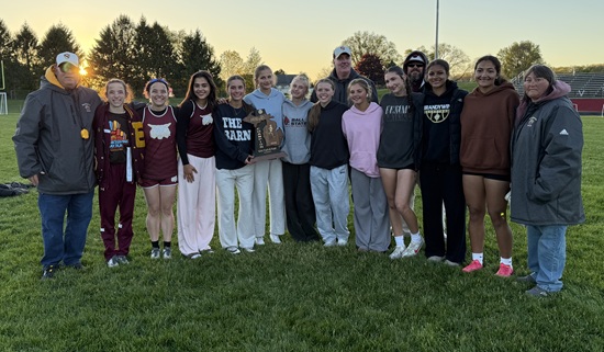 The Niles Brandywine girls track & field team and coaching staff pose for a photo with the 2026 Division 3 Regional trophy at Bangor. 