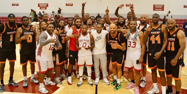 Spencer, far left, poses with the rest of the Muskegon Heights and Muskegon High alumni teams after last season’s Hoop City matchup. 
