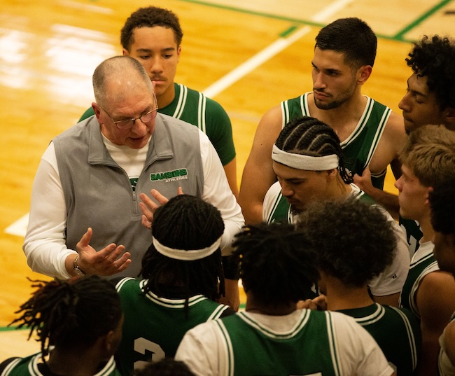 Mackey huddles with his players during a break.