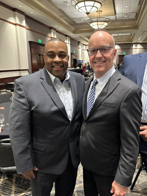 White stands for a photo with BCAM Executive Director Dan Young. 