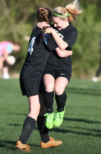Angelynn Kotch, right, jumps into sister Electra’s arms.