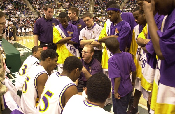 Morton, kneeling, speaks to his team during the 2002 Class B Final.