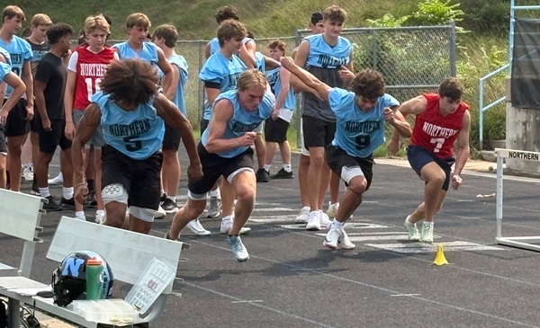 Owen Ostipow, far right, runs sprints on the track with his teammates.