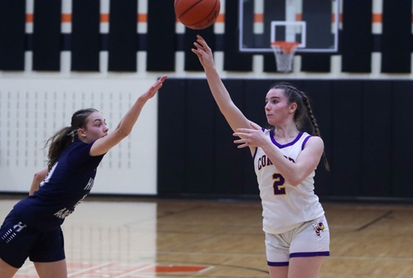 Stimer passes the ball during a basketball game against Hillsdale Academy.