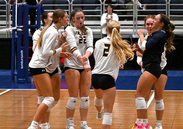 The Chargers, including Kate Belt (22), celebrate a point.