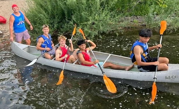 Visiting players take advantage of a chance to go canoeing.