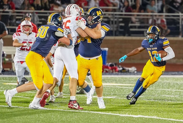 KV Korenstra (12) follows his blockers against Spring Lake.