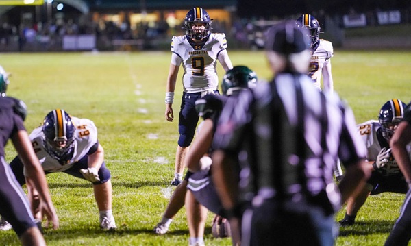 Senior quarterback Easton Hintz (9) prepares to take a snap against Reeths-Puffer. 