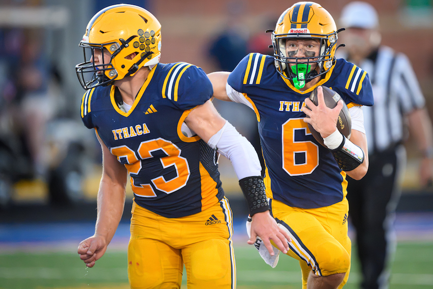 Ithaca’s Greyson Merchant (6) follows senior Harper Merchant for a first down during the Yellowjackets’ 63-7 win over Saginaw Nouvel Catholic Central.
