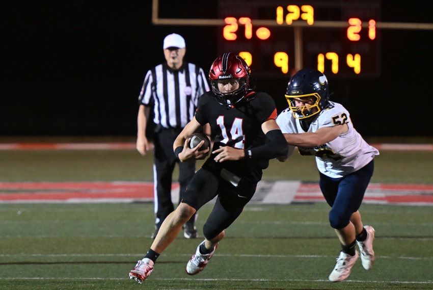 Marquette's Winston Leonard keeps the ball as Cadillac's Westin Hamp pursues and eventually tackles him.