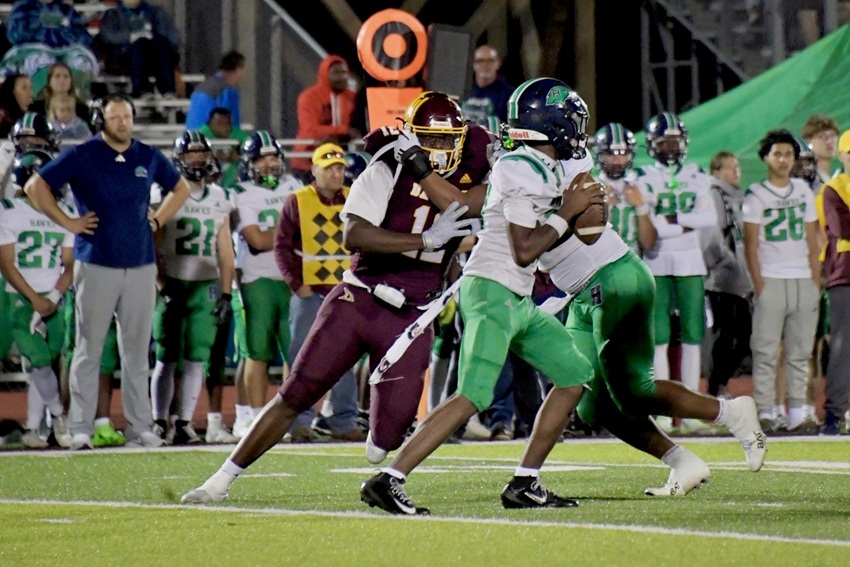 A Davison pass rusher pursues the Saginaw Heritage quarterback Friday.