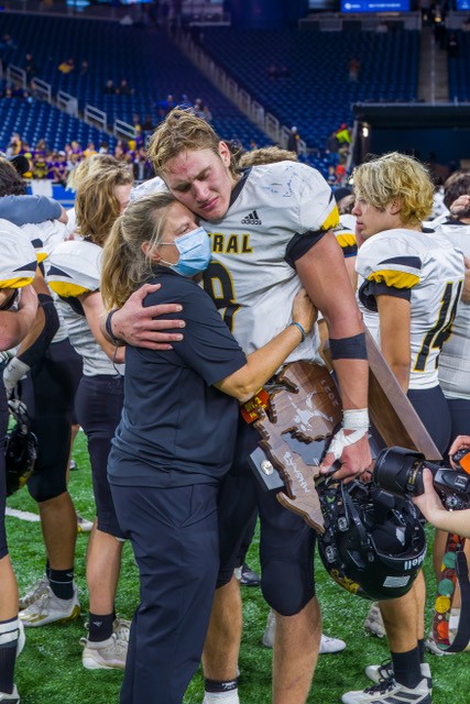 Ream and Josh Burnham embrace after the latter’s final high school football game, at Ford Field. 