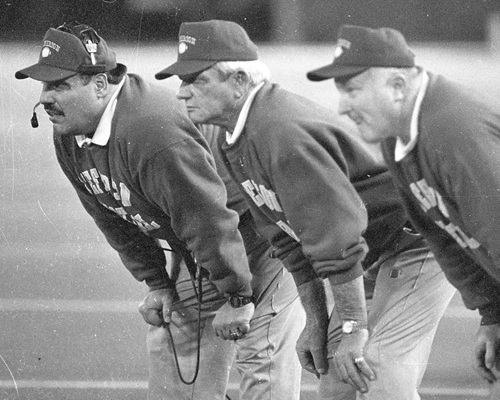 From left, John Castiglione, Cisco and Dave Potter monitor the action at the Silverdome during their team’s 1994 Class B Final.