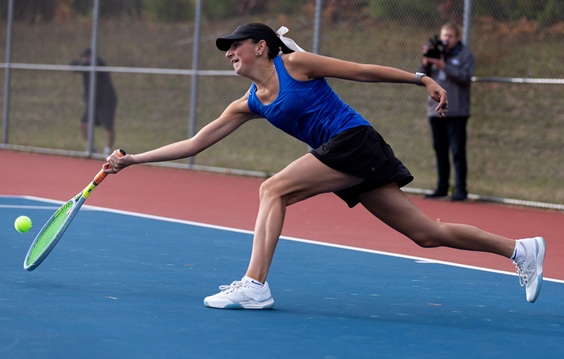 West Iron County’s Grace Smith reaches to get to a shot at No. 1 singles.