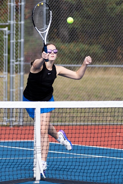 Stella Nerlfi sends a shot back over the net for Ishpeming at No. 1 doubles.