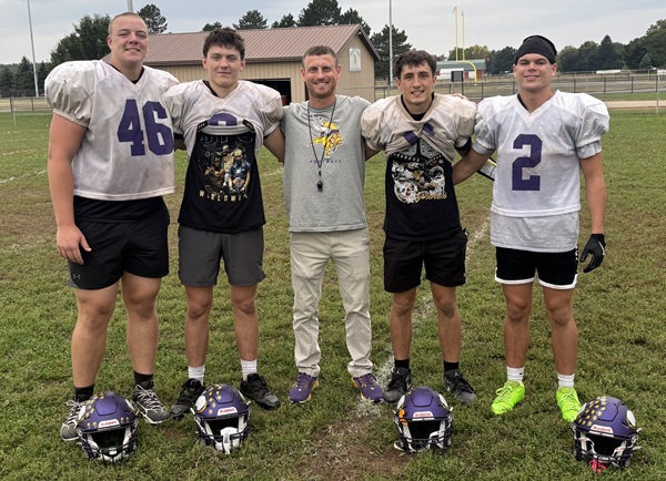Bronson players (from left) Kyle Hyska, Reid Stukey, Caleb Harvey and Ben Stevens pose for a photo with head coach Tony Myers after a practice. 