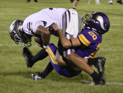 Reid Stukey (20) tackles a Buchanan receiver following a reception.