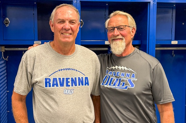 Ravenna assistant coaches Randy Helsen, left, and Dusty Fairfield are pictured in the Bulldogs' locker room in August.