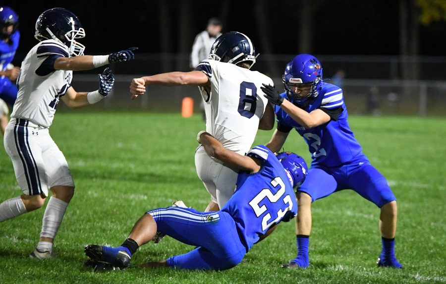 Fowler’s Eli Thelen (8) is brought down by Bath’s Lorenzo Gonzalez (23) and Hunter Tolliver (2) during the Eagles’ 53-0 win.